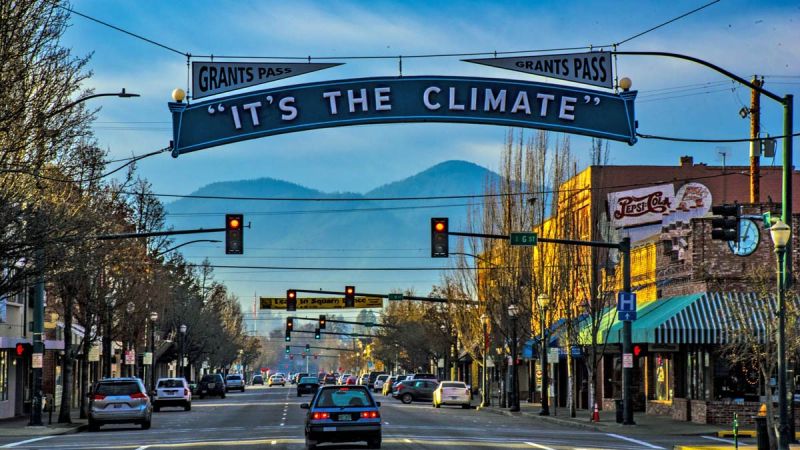 Grants Pass, Oregon downtown with banner saying It's The Climate