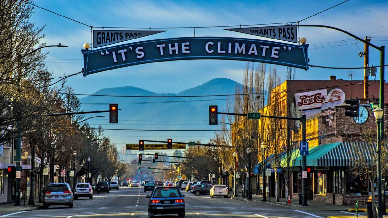 Grants Pass, Oregon downtown with banner saying It's The Climate
